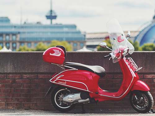 motor scooter red motor scooter parking near wall motorcycle